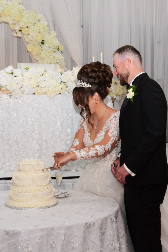Fun cutting of the cake at The Double Tree by Hilton by Columbia Photos