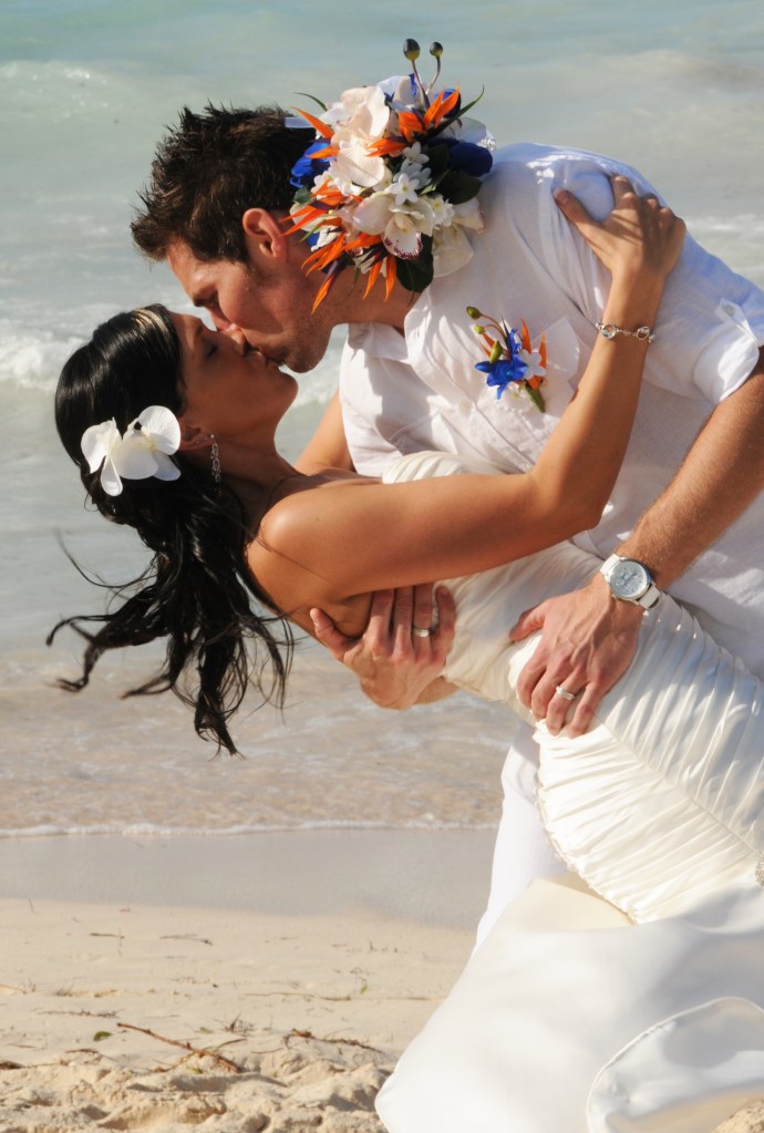 Kissing on the beach by Columbia Photos based in London Ontario