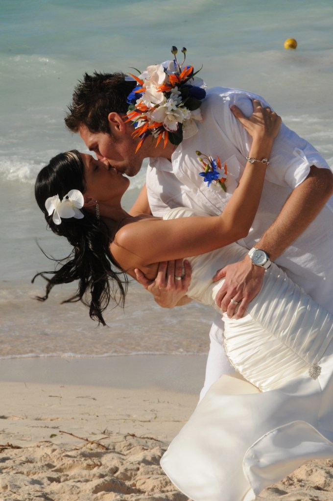 Kissing on the beach by Columbia Photos based in London Ontario